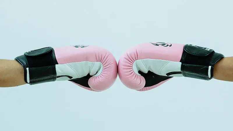 Fist bump while wearing boxing gloves